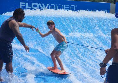 Boy surfing on wave machine